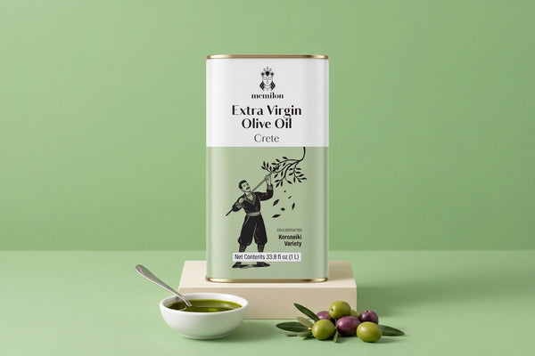 Cold pressed olive oil: Memilon Crete extra virgin olive oil tin on a cream plinth beside a bowl of olive oil and fresh olives