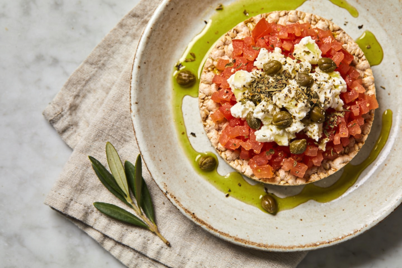 Cretan dakos on a ceramic plate, overhead, natural light